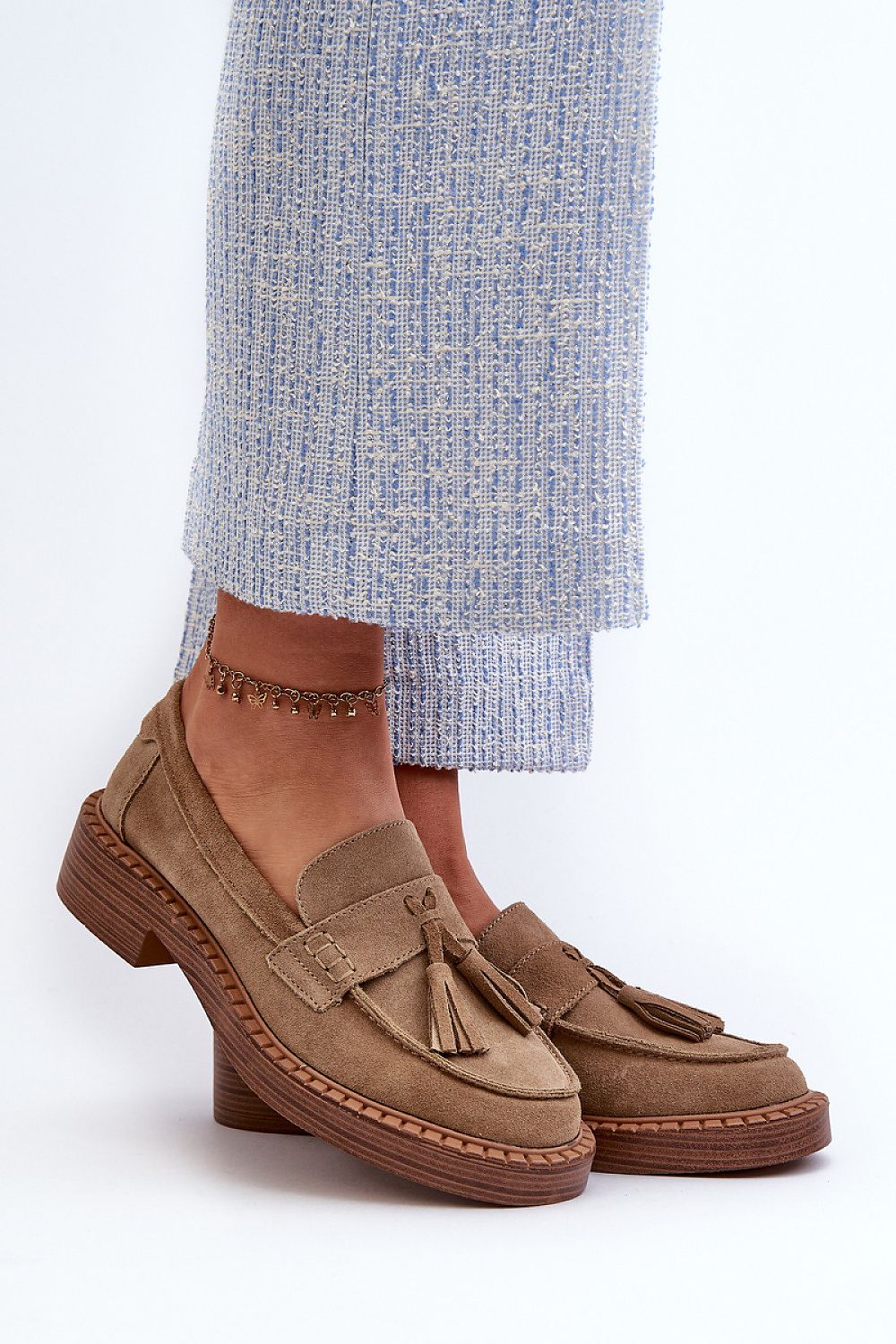 Elegant women's suede moccasins from Step in Style featuring charming tassels, crafted for luxurious comfort and style.