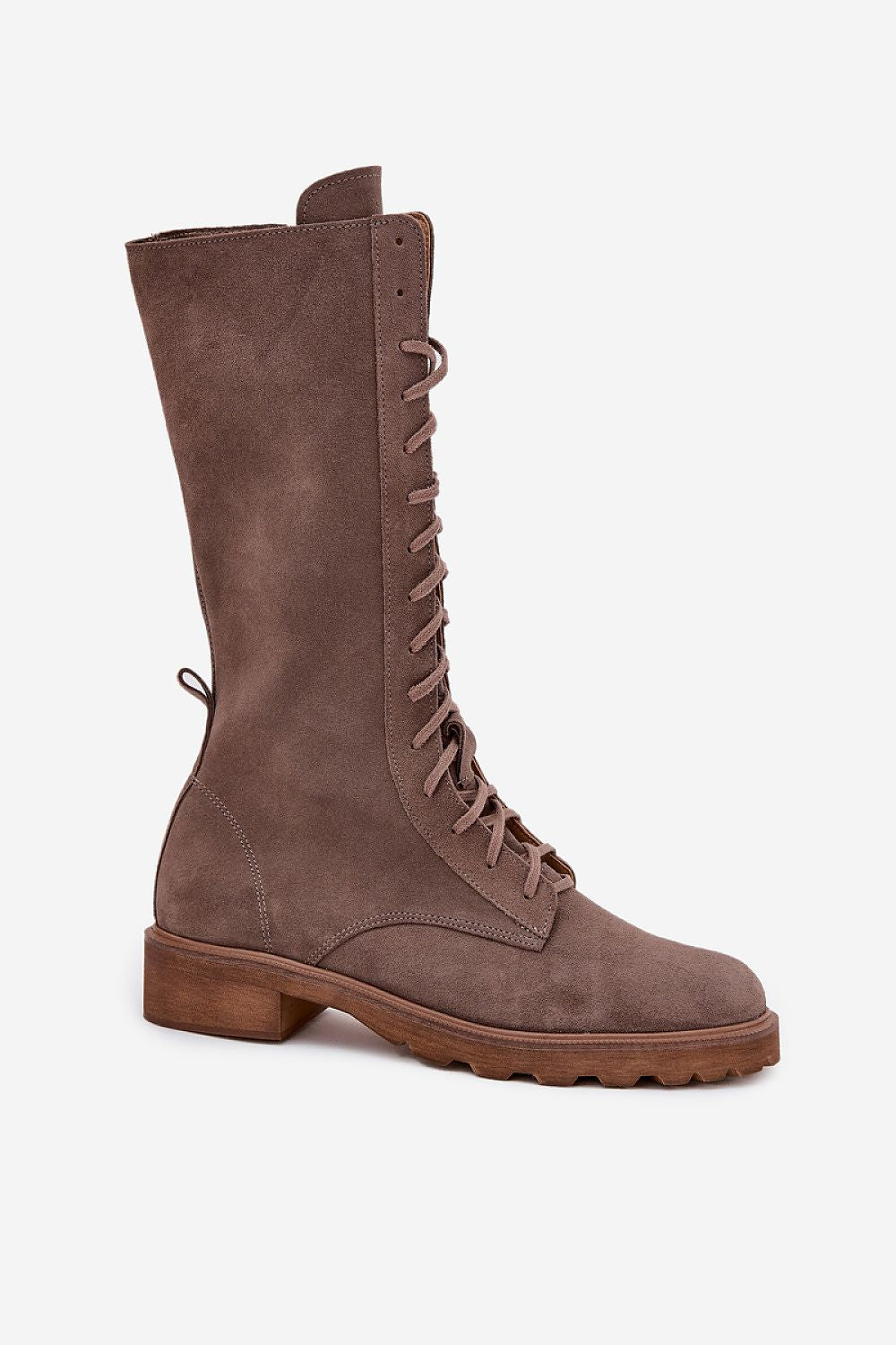 Close-up view of Step in Style's stunning women's suede ankle boots with detailed lacing and zipper closure, perfect for sophisticated styles.