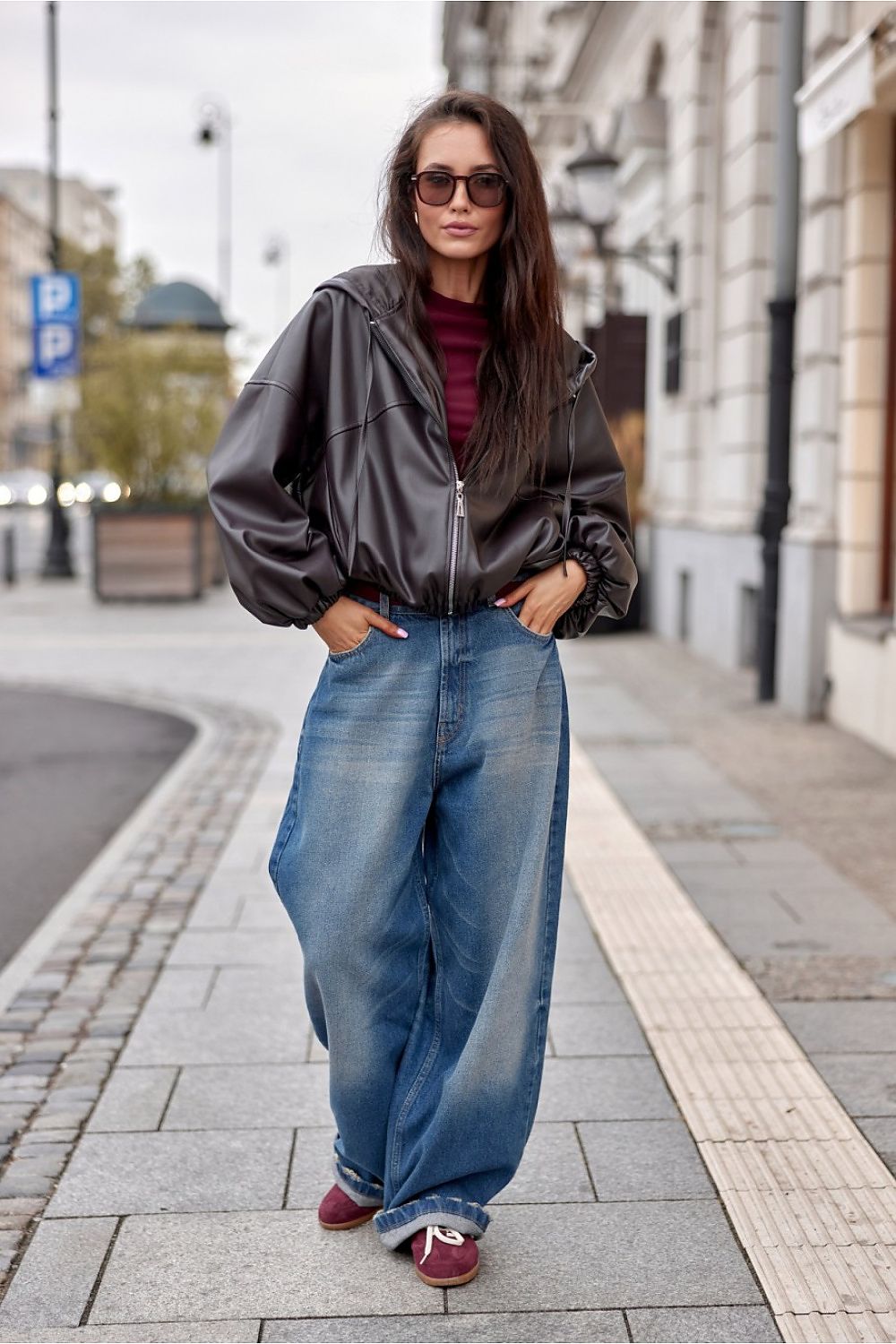 Elegant Roco Fashion Eco-Leather Jacket displayed on a hanger, emphasising the oversized cut and stylish hood design for sophisticated streetwear.