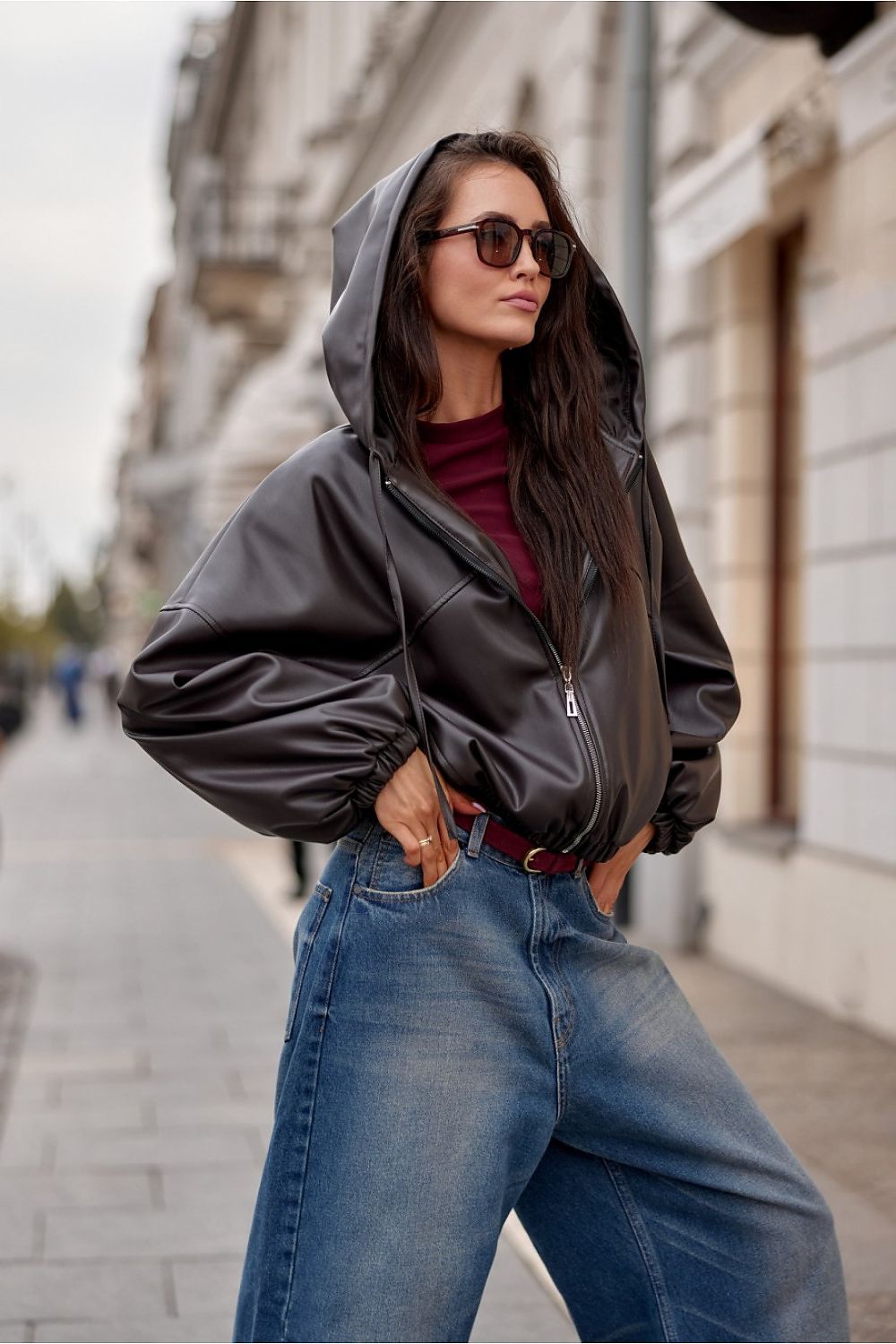 Lifestyle shot of a model wearing the Roco Fashion Oversized Eco-Leather Jacket with Hood, highlighting its comfortable fit and trendy aesthetic.