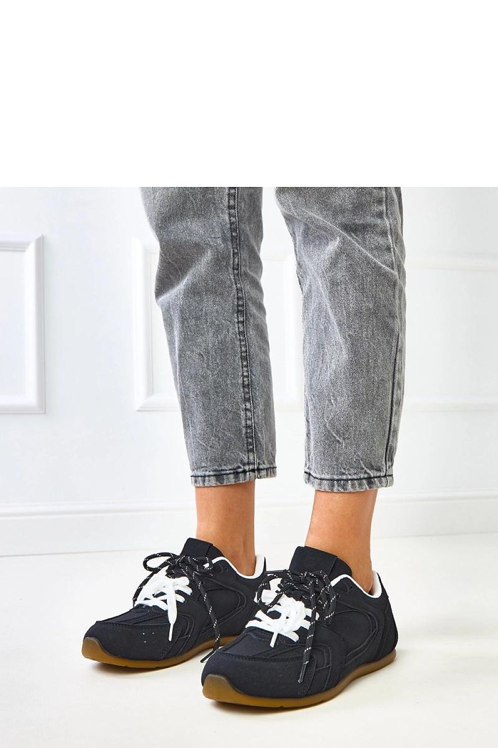 Elegant Solea eco-friendly suede sport shoes displayed on a minimalist background, highlighting their versatile styling potential.