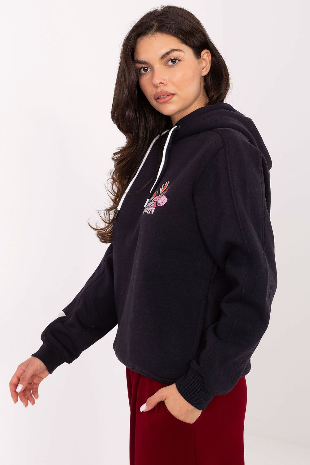 Close-up of Sublevel women's casual sweatshirt featuring adjustable drawstrings and elegant patch detail on the sleeve for a sophisticated touch.