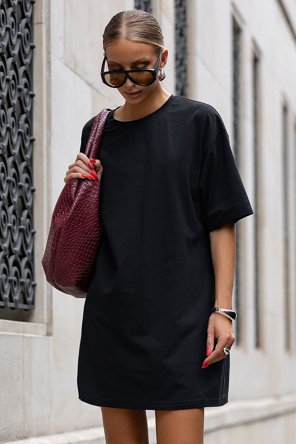 Model wearing IVON oversized cotton dress, perfectly styled with boots for a chic look, demonstrating versatile fashion for every silhouette.