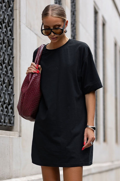 Model wearing IVON oversized cotton dress, perfectly styled with boots for a chic look, demonstrating versatile fashion for every silhouette.