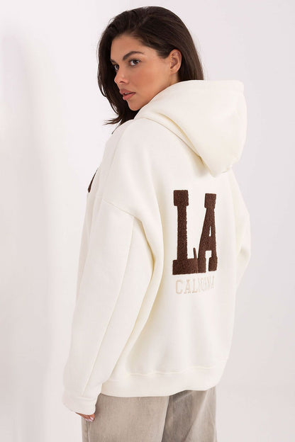 Stylish detail of the embroidered inscriptions on the Factory Price luxury cotton-polyester hoodie sweatshirt for women, showcasing contemporary design.