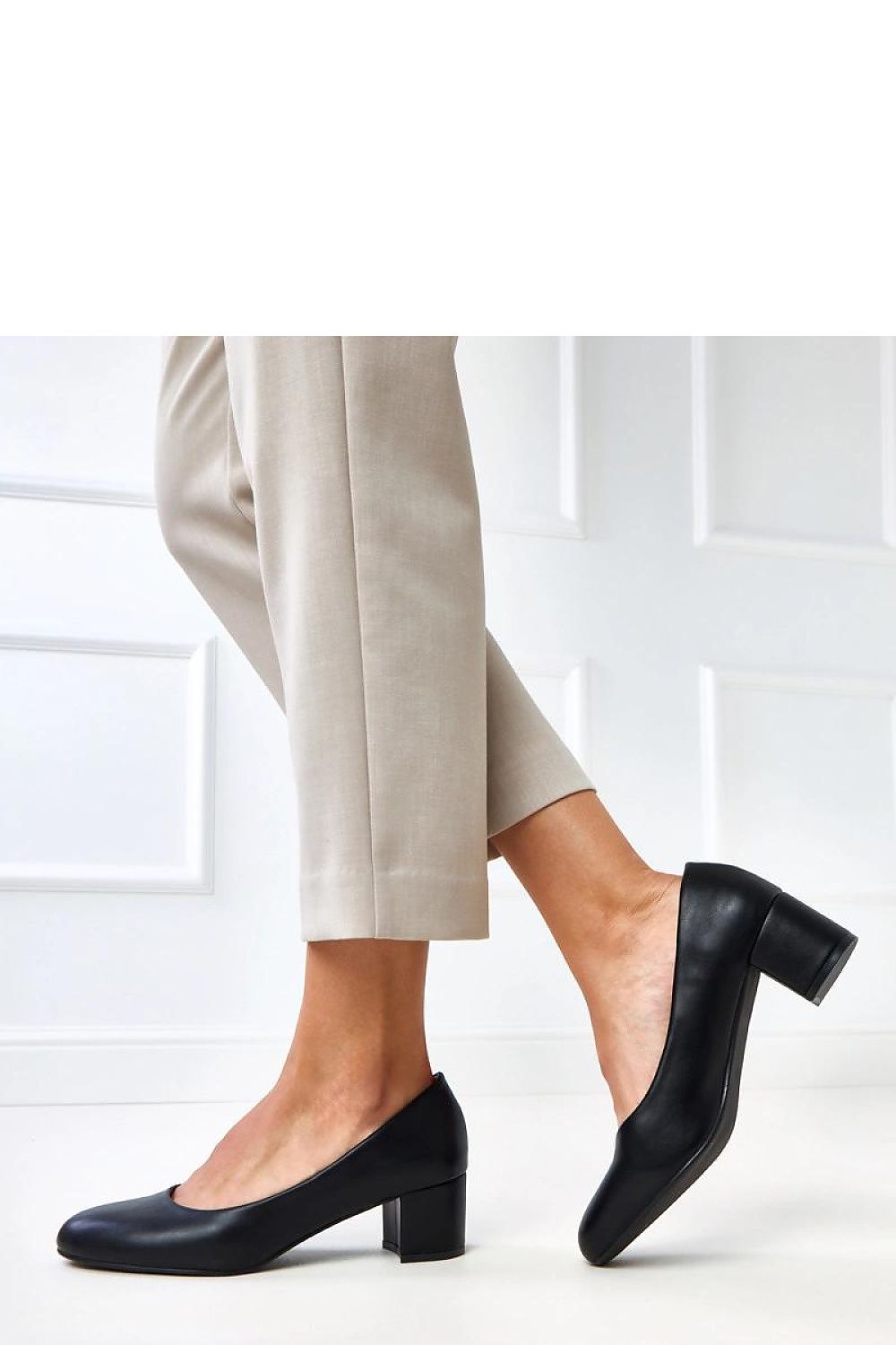 Stylish round toe women's block heel pumps by Solea, designed for comfort and stability, made from premium faux leather.