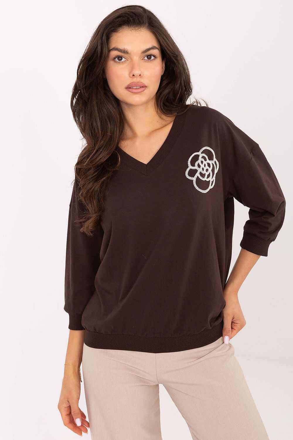 Elegant V-neck blouse in cotton blend with subtle embroidery, designed by Relevance, showcasing a feminine silhouette and 3/4 sleeves.