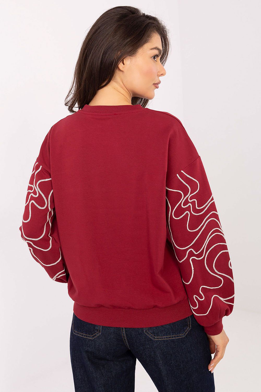 Model wearing Relevance's luxury women's embroidered cotton-blend sweatshirt, perfect for casual outings with a chic and timeless look.