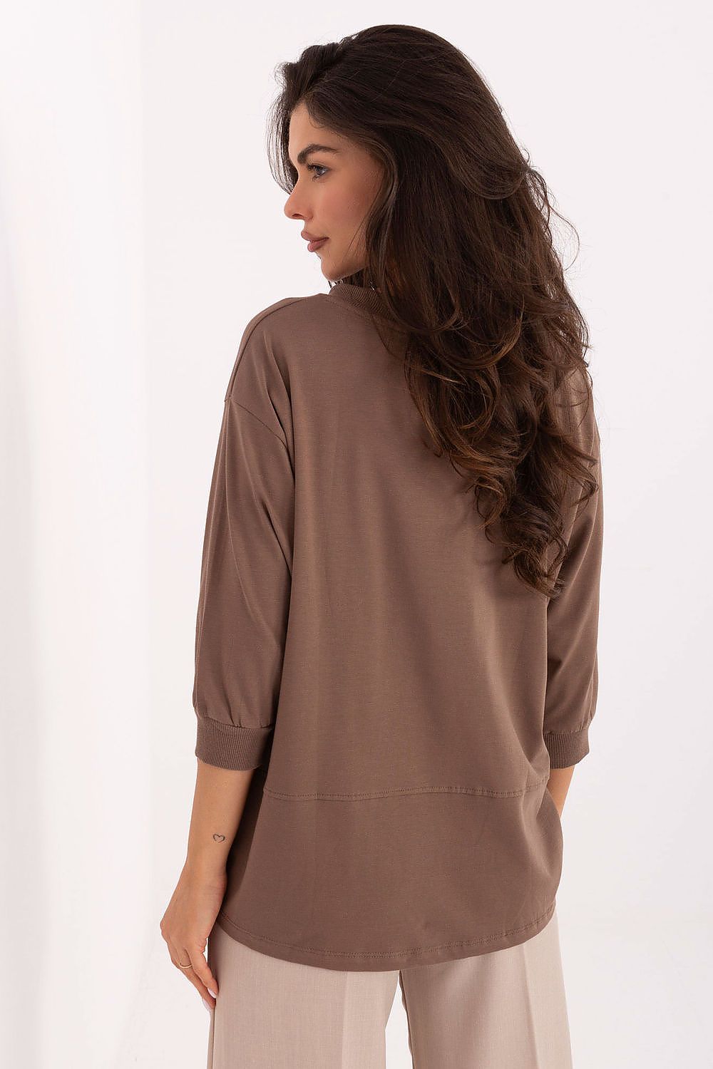 Back view of the Luxury Casual Cotton Blend Blouse by Relevance, designed with comfortable 3/4 sleeves and modern patch detailing on the left side.