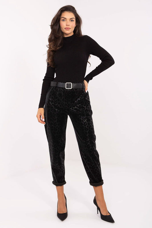 Luxury women's high-waisted faux leather trousers with a bold leopard print design by Italy Moda, showcasing a stylish fitted silhouette and tapered legs.