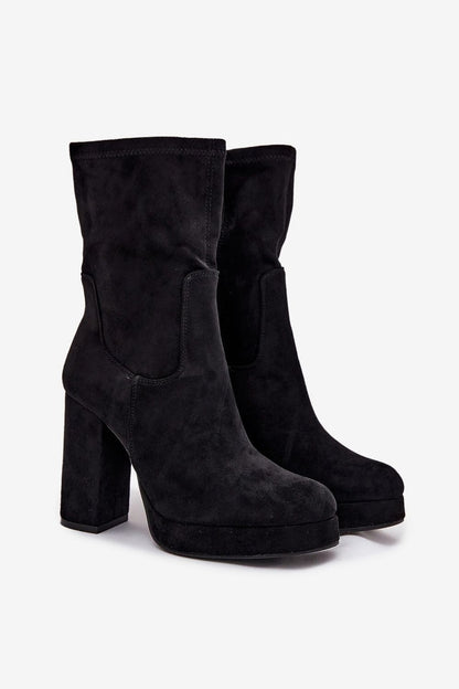 Step in Style's luxurious eco suede ankle boots modelled in black, featuring a high column heel and a warm shoe blanket lining for maximum comfort and elegance.