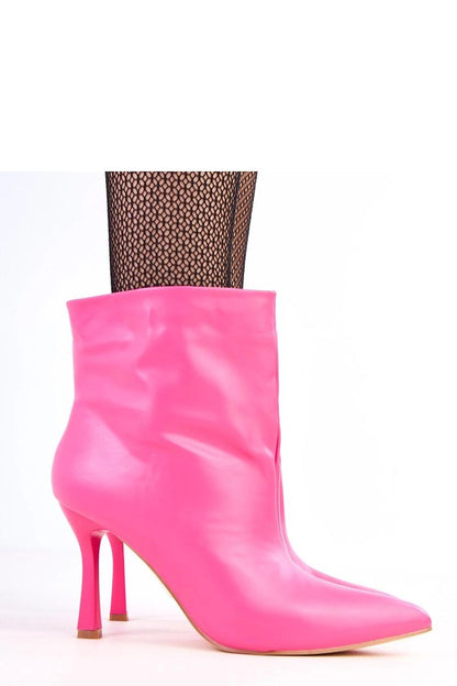 Close-up of Solea's eco-friendly leather ankle boots showcasing their glossy finish and stylish pointed toe, ideal for a chic and confident silhouette.