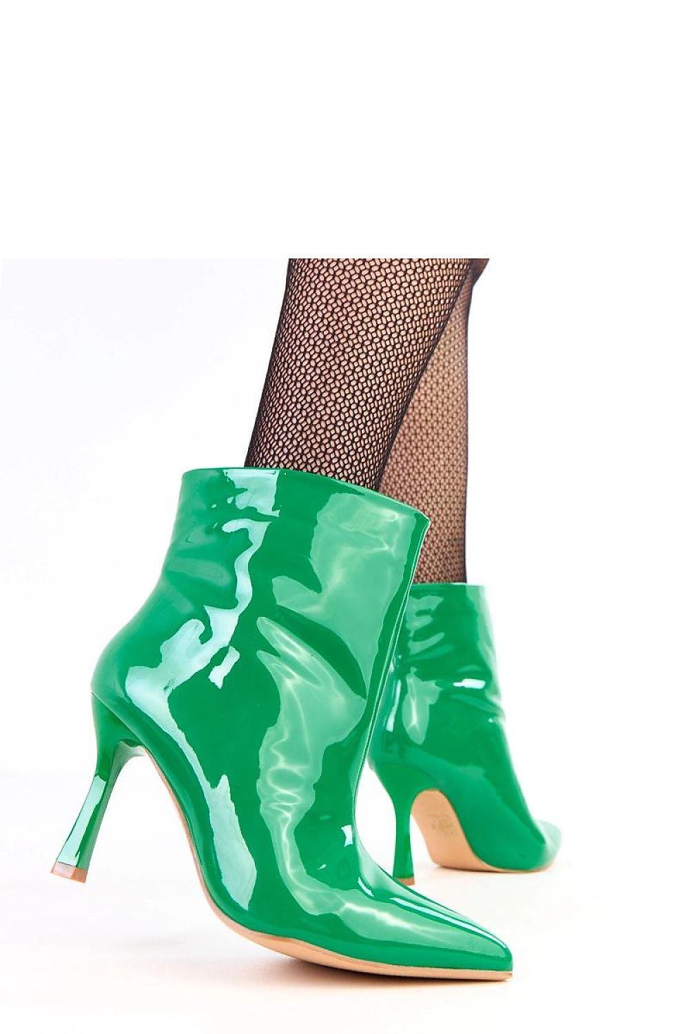 Solea stiletto ankle boots elegantly styled with a chic outfit, featuring a graceful silhouette and lightweight synthetic sole, ideal for both casual and formal occasions.