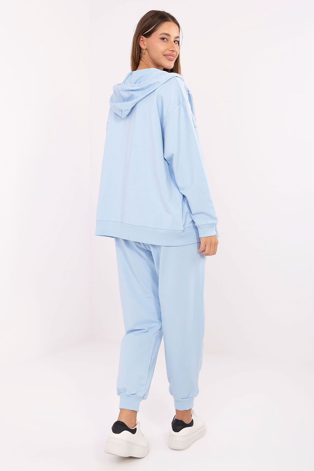 Relevance's elegant women's tracksuit set displayed in a lifestyle setting, highlighting the functional pockets and subtle print detail.