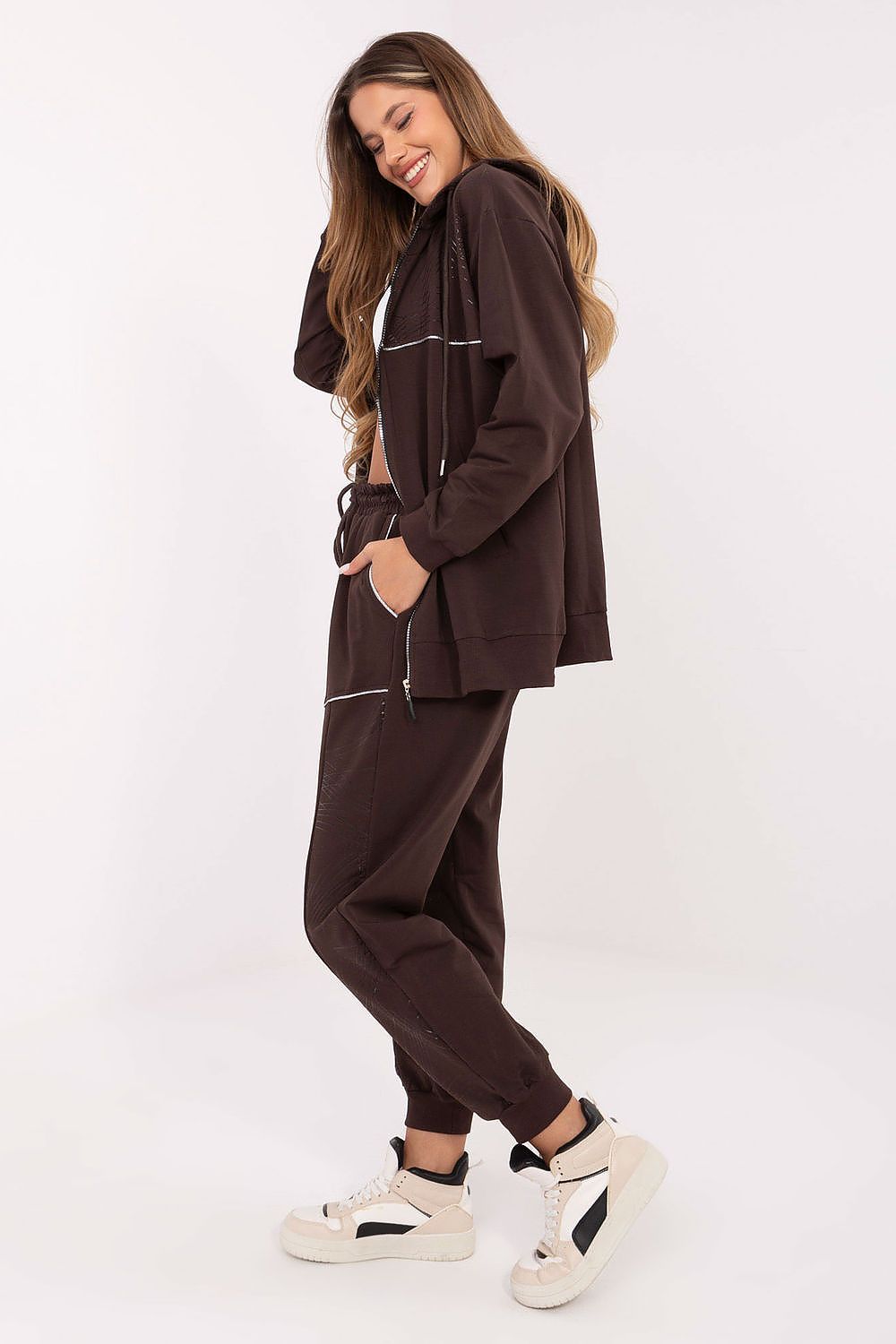 Luxury women's casual tracksuit set featuring high waist pants and zip-up hoodie by Relevance, showcasing functional pockets and a fashionable subtle print.