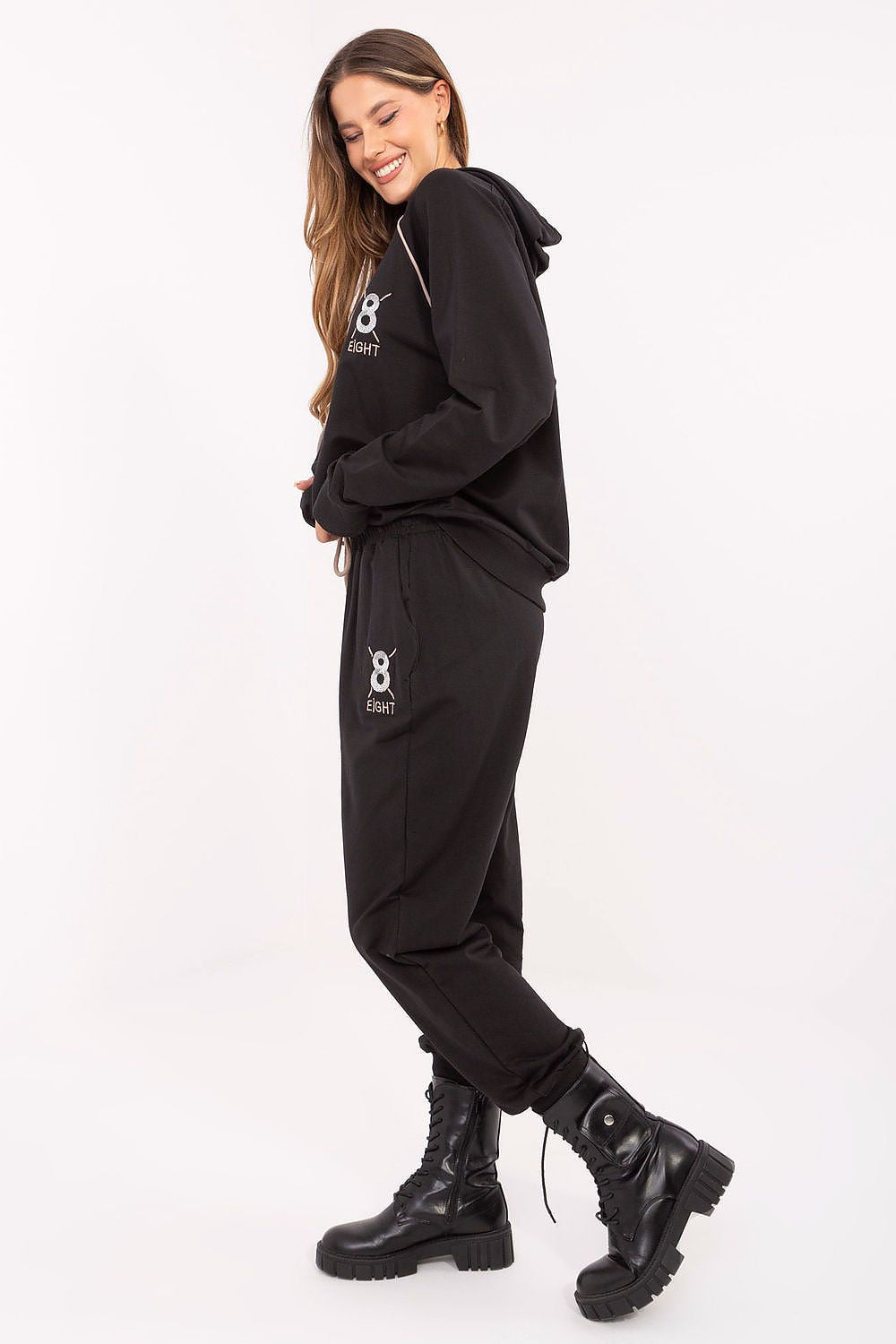 High-waisted track pants with functional side pockets, part of the sophisticated women's tracksuit set by Relevance.