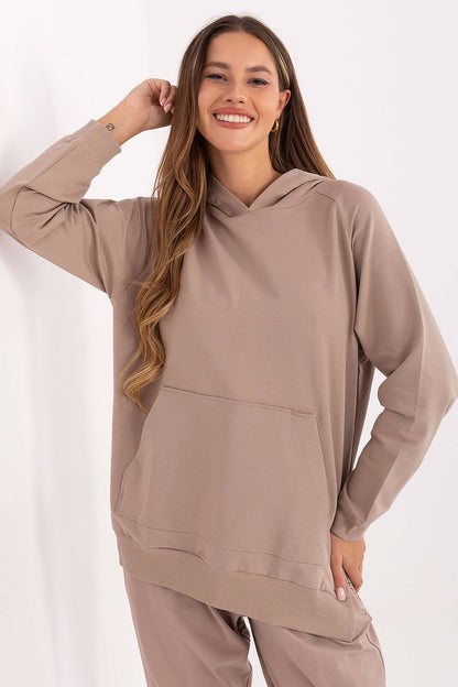 Trendy oversized women's sweatshirt in cotton and spandex blend with a hood, by Relevance, showcasing a modern silhouette with side slits for a fashionable touch.