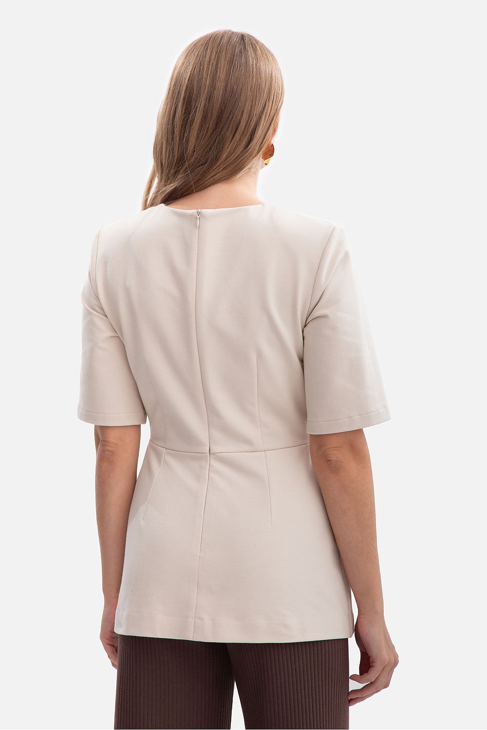 Elegant BeWear blouse displayed on a hanger, highlighting the classic round neckline and feminine silhouette designed for sophistication.