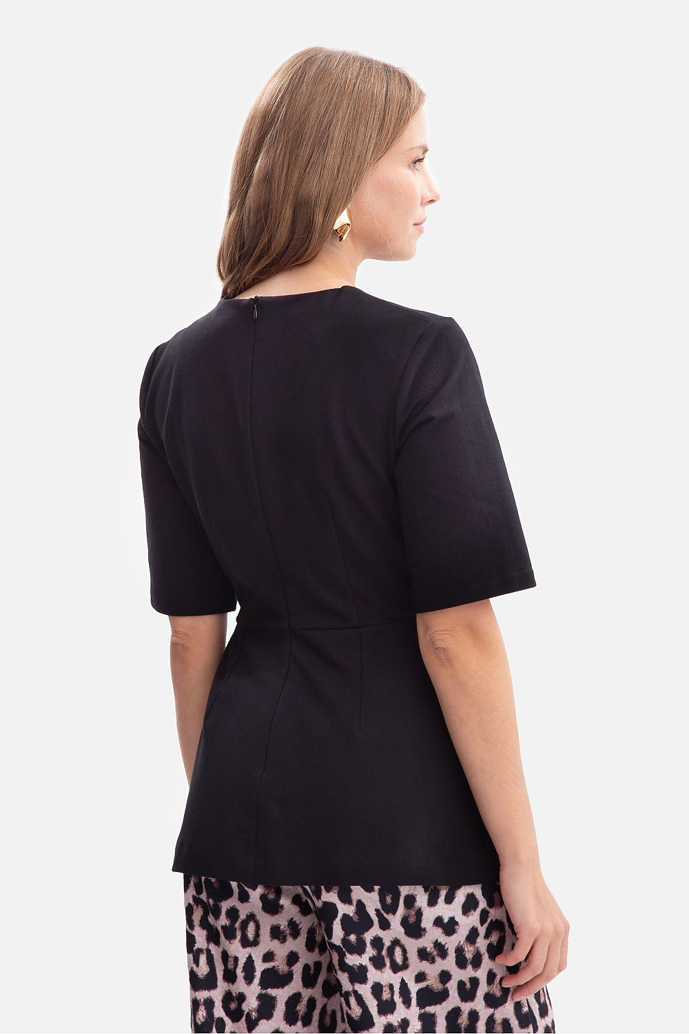 Side view of the BeWear blouse illustrating the feminine silhouette and elbow-length sleeves for a refined look.