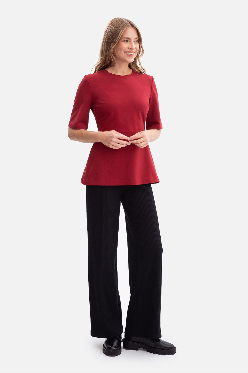 Elegant BeWear blouse featuring a flared peplum design, crafted from a luxurious cotton/spandex blend, ideal for sophisticated occasions.