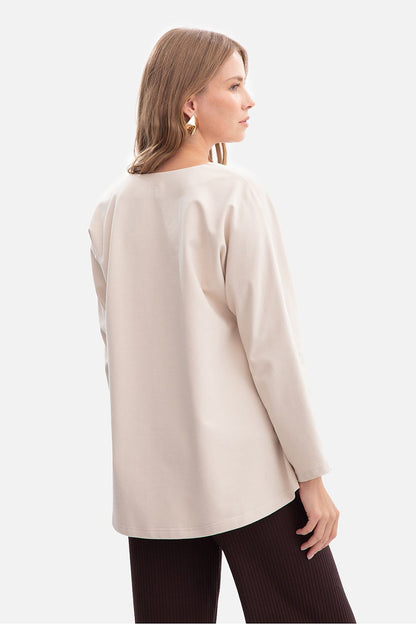 BeWear Women's V-Neck Blouse displayed on a model, demonstrating its flattering loose silhouette and modern styling, suitable for various occasions.