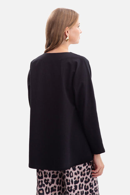 Elegantly styled BeWear oversized women's V-neck blouse made from a soft cotton blend, showcasing its relaxed fit and flattering neckline.