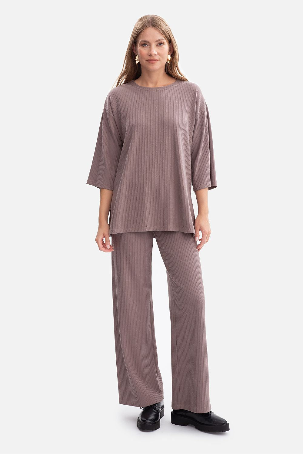 Model wearing the BeWear Women's oversized ribbed blouse, styled with chic trousers for a sophisticated look.