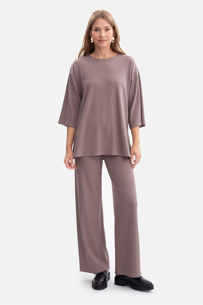 Model wearing the BeWear Women's oversized ribbed blouse, styled with chic trousers for a sophisticated look.