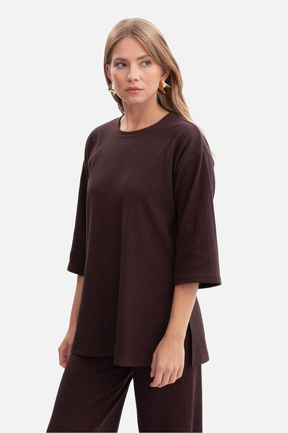 Luxurious BeWear Women's ribbed blouse displayed on a hanger, emphasizing its classic round neckline and timeless design.