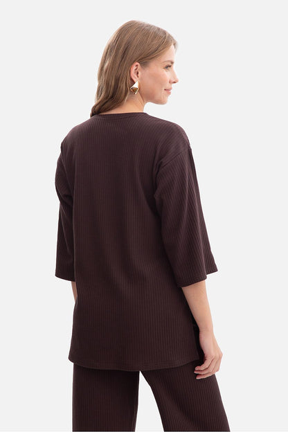 Close-up view of BeWear Women's Ribbed Blouse fabric, highlighting the luxurious ribbed texture in an elegant casual design ideal for versatile styling.