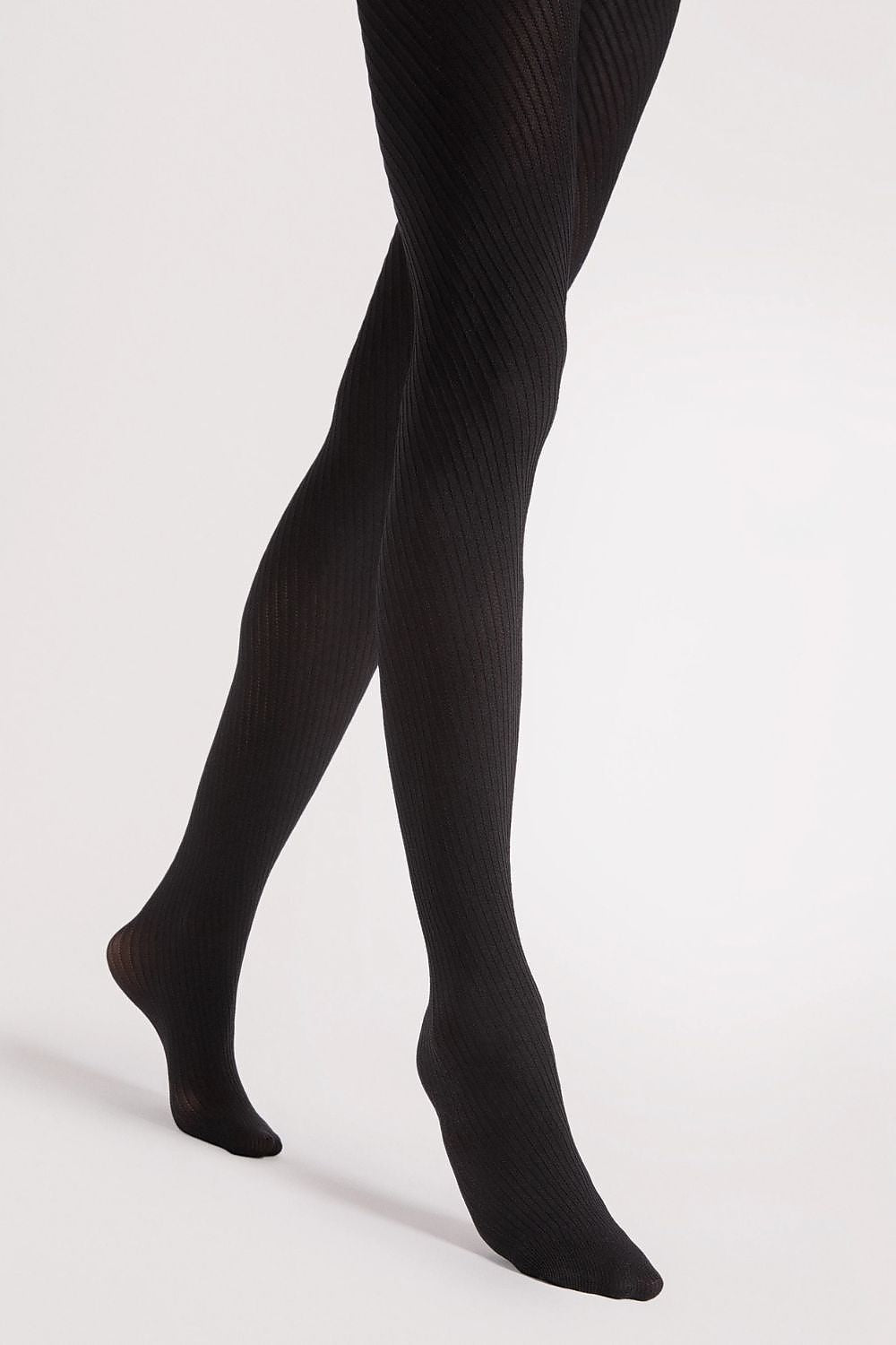 Close-up of Fiore Warm Matte Tights fabric detail emphasizing luxurious, subtle texture and sophisticated elegance.