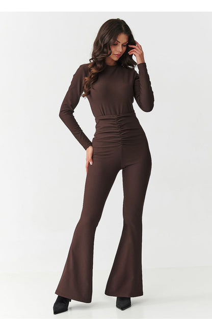 Elegant Women's Set by Makadamia featuring a fitted blouse with a high neckline and long sleeves paired with high-waisted flared pants in luxurious burgundy ribbed fabric.