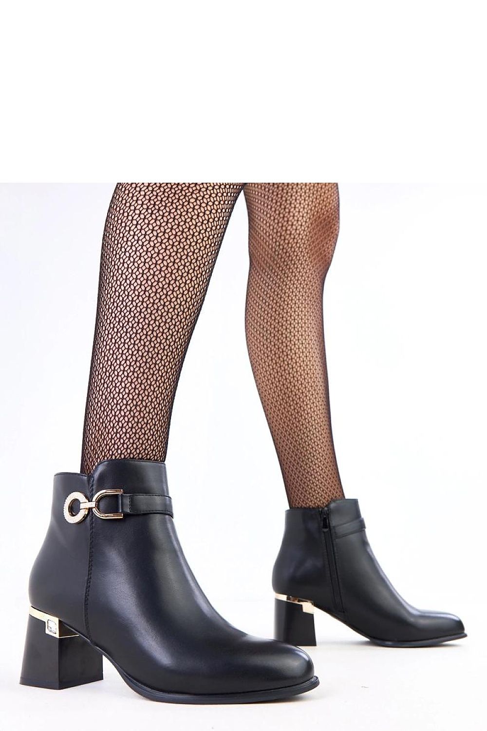 Close-up of Solea ankle boots showcasing the sleek matte eco-leather finish and stylish metal decorations, perfect for sophisticated outfits.