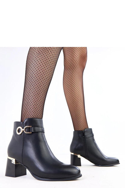 Close-up of Solea ankle boots showcasing the sleek matte eco-leather finish and stylish metal decorations, perfect for sophisticated outfits.