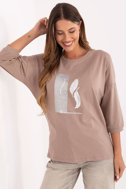 Graceful display of Relevance's 3/4 sleeve women's blouse with a shimmering metallic design, integrating comfort and luxury for casual wear.