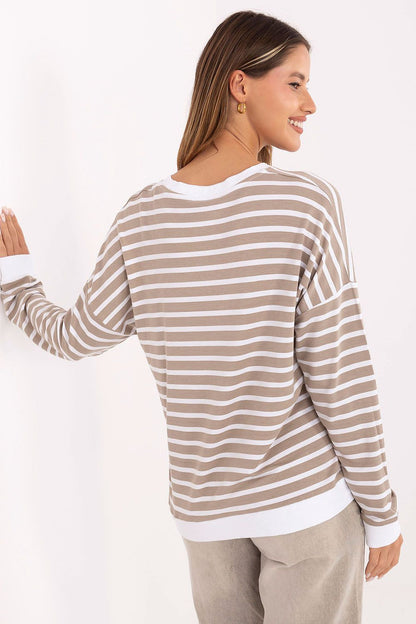 Chic and comfortable oversized blouse from Relevance, featuring a round neckline and ribbed finish, ideal for pairing with skirts or trousers for a stylish look.