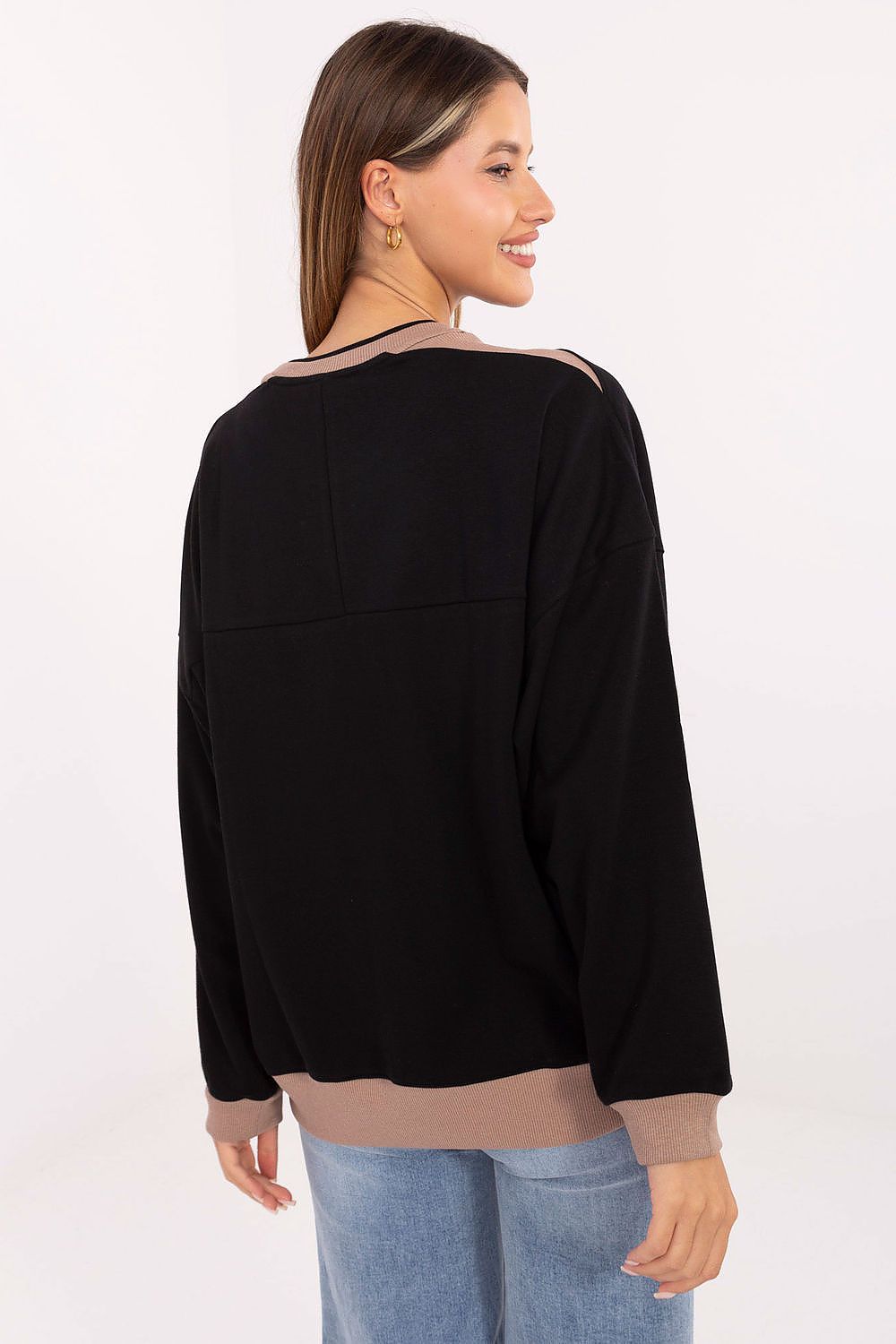 Attire styled with Relevance's embroidered women's sweatshirt, exemplifying casual elegance and sophisticated comfort.