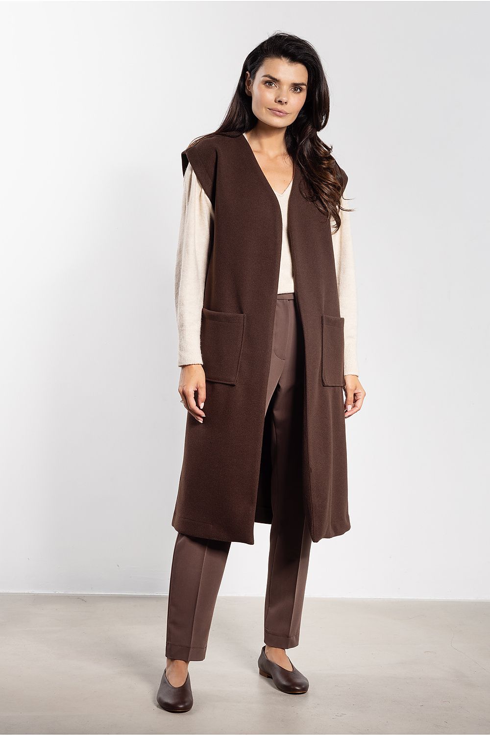Stylish Awama women's gilet vest with belt and large pockets, crafted from soft fleece in modern cut for trendy layering.