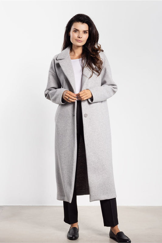 Elegant women's midi coat by awama, featuring a minimalist design and classic lapels, showcased in a luxurious autumn setting.