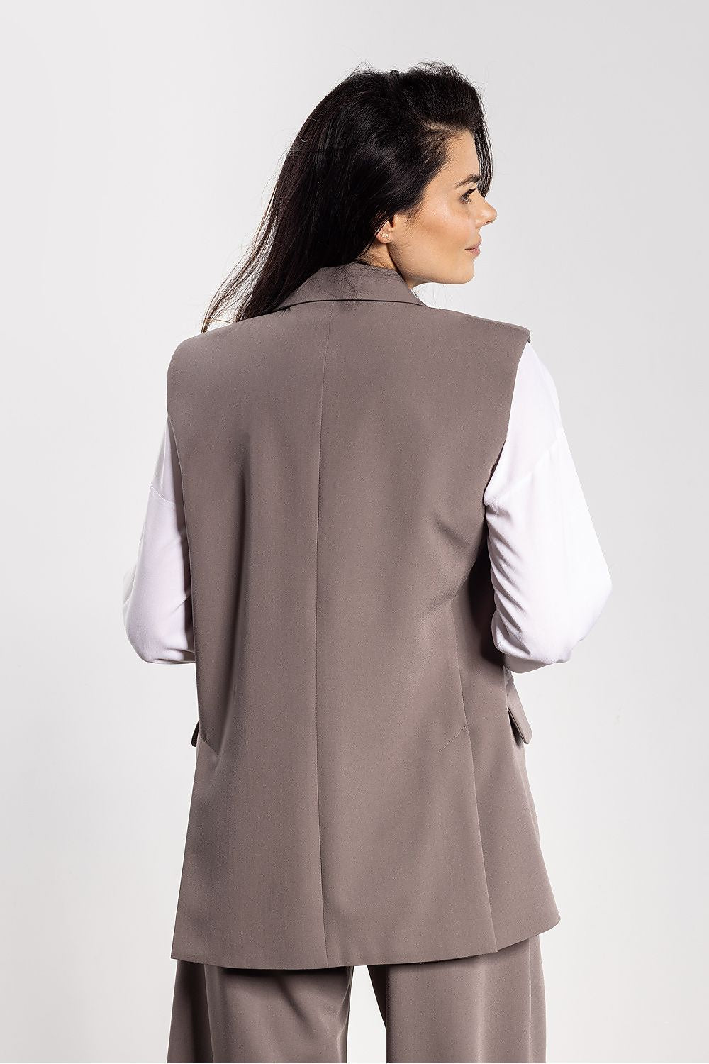 Side view of Awama Gilet Vest for Women, highlighting the sophisticated flap pockets and slimming silhouette, ideal for elegant business casual outfits.