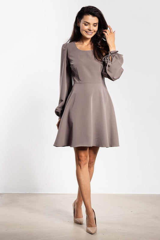 Side view of the elegant mini dress with puffy sleeves by Awama Fashion, highlighting the flared cut and feminine charm.