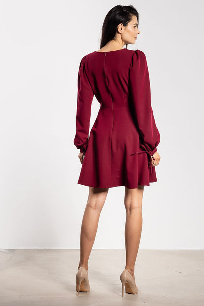 Close-up of the decorative tie detail on the flared mini dress by Awama Fashion, showcasing elegance and originality.