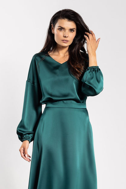 Elegant satin blouse by Awama featuring a sophisticated V-neckline and long sleeves, designed for luxury and comfort, available in sizes S to XL.