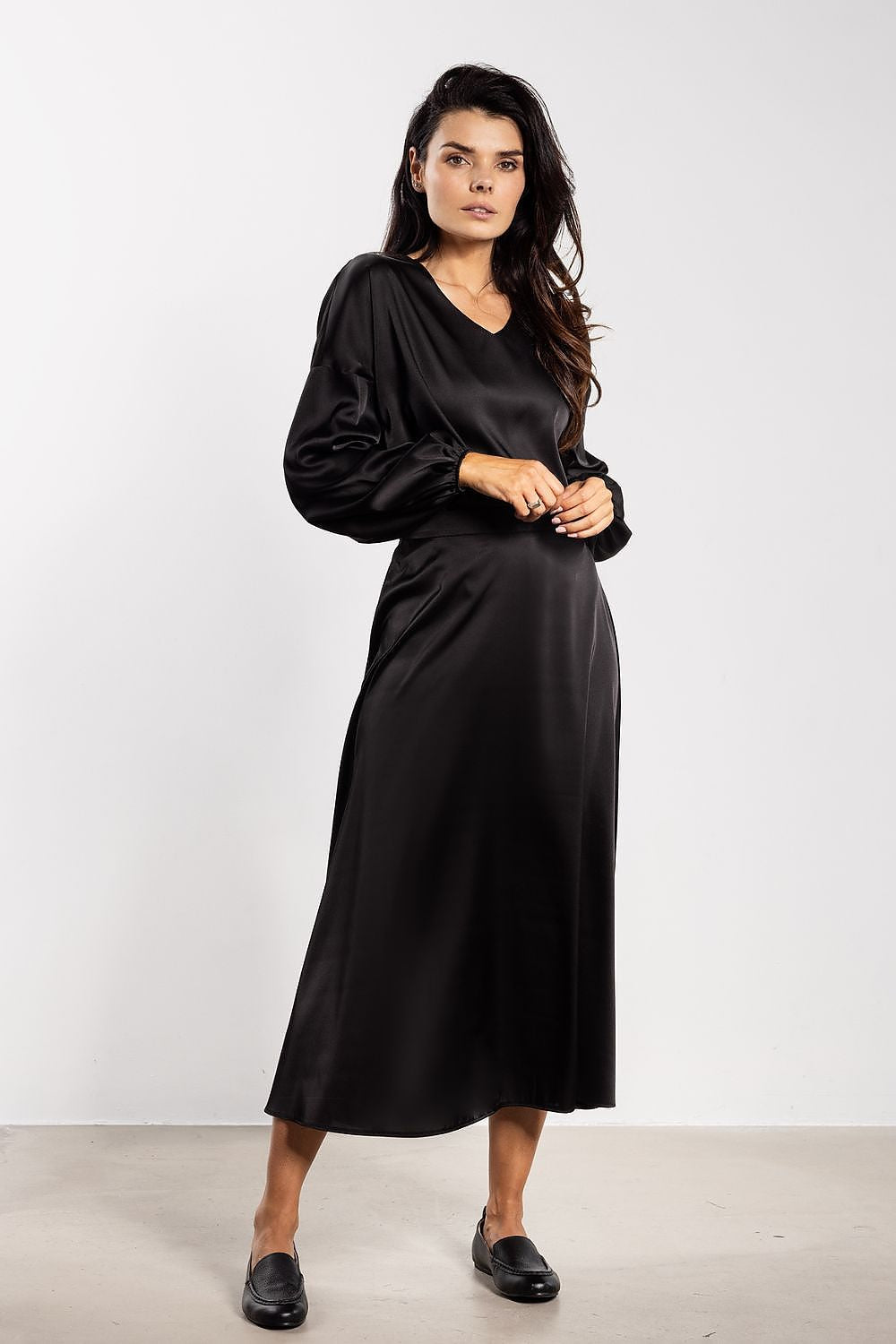 Model wearing Awama's elegant satin blouse with a loose fit and subtle ruching at the cuffs, exuding comfort and elegance.