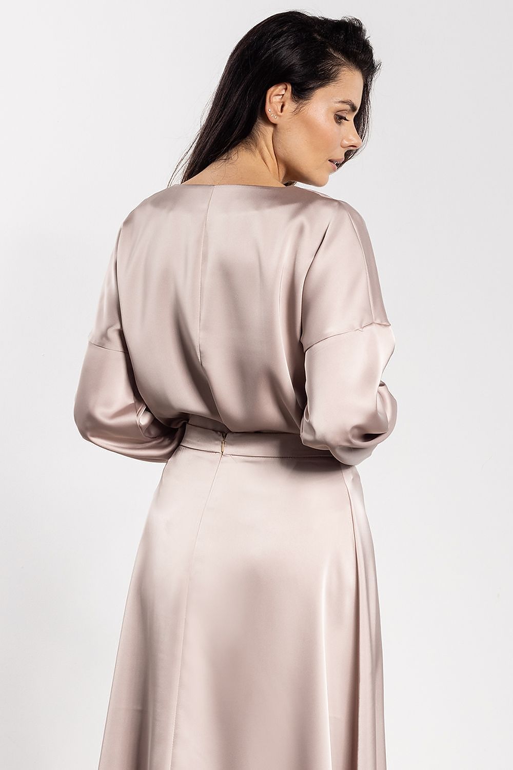 Close-up detail of Awama's luxurious satin blouse displaying the ruching at cuffs, enhancing elegance and comfort.