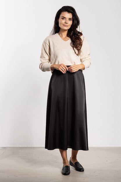 Elegant satin midi skirt by Awama showcasing a flared cut and high waist design, ideal for both casual and formal occasions.