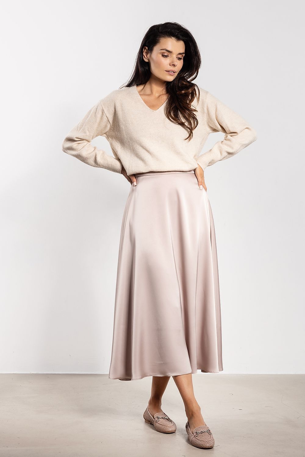 Awama's luxurious satin midi skirt displayed in various sizes, offering a perfect blend of comfort and elegance with its high waist and flared style.