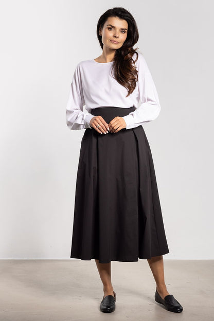 Flared bottom silhouette of the luscious midi skirt by Awama, accentuating the waist while maintaining a sophisticated look.