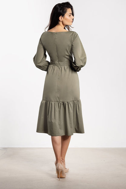 Close-up view of Awama's romantic ruffle details on a chic midi dress, adding a luxurious touch to any outfit.