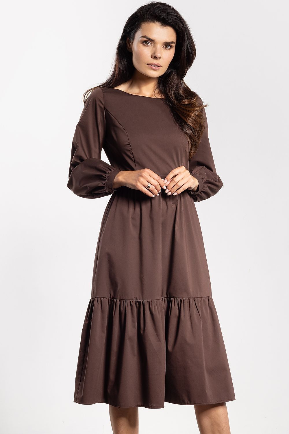 Awama elegant midi dress displayed on a model, demonstrating its graceful flared silhouette and refined long sleeves.